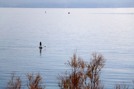 Silhouette of an unrecognizable person stand up paddling in Split, Croatia.