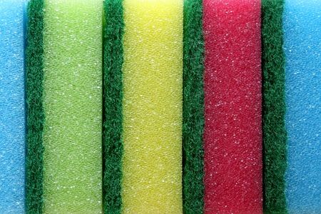 Stack of colorful sponges on pink background. Top view.の写真素材