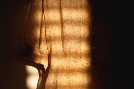 Vintage yellow floral dress, illuminated by sunlight. Selective focus.の写真素材