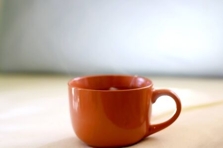 Cup of tea on a bed. Selective focus.