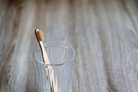 Bamboo toothbrush in a glass. Selective focus.の写真素材