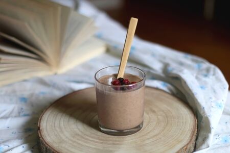 Banana and cinnamon nice cream and open book on a bed. Selective focus.の写真素材