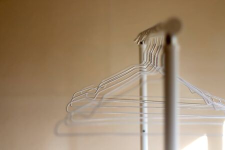 White empty hangers on a clothing rack. Selective focus.の写真素材