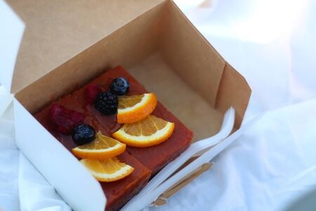 Box with sugarfree fruit cake, served on a picnic. Selective focus.の写真素材