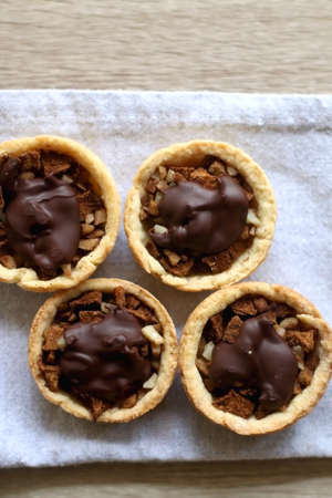 Pastry baskets filled with apples, almonds and dark chocolate. Top view.