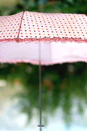 Cute pink umbrella outdoor. Selective focus.の写真素材