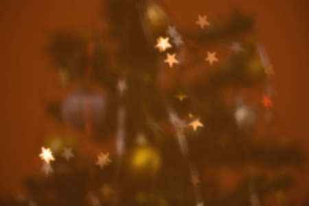 Star shaped Christmas lights on the tree. Defocused Christmas background.の写真素材