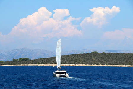 Sailing boat and beautiful island in Dalmatia, Croatia.の写真素材