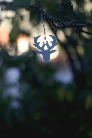 Reindeer Christmas ornament hanging on the tree outdoor. Selective focus.の写真素材