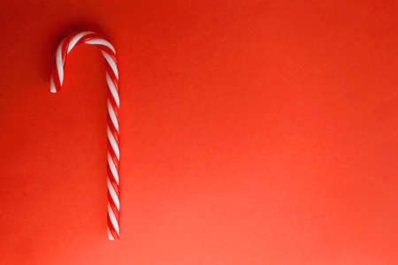 Candy cane decoration on red background. Top view.の写真素材