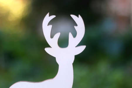 White reindeer figurine. Simple Christmas decoration. Selective focus.の写真素材
