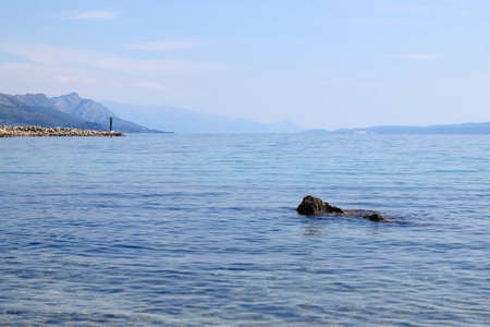 Clear sea and small lighthouse on the beach in Split, Croatia.