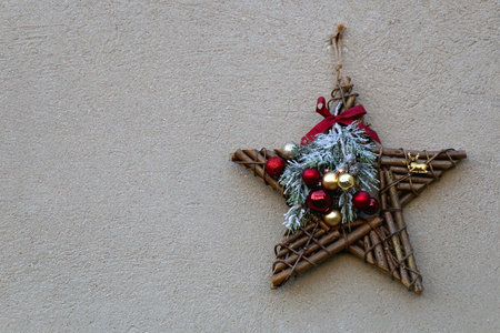 Decorative Christmas star hagning on the concrete wall.の写真素材