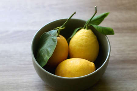 Bowl of lemons on a table. Selective focus.