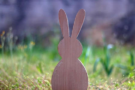 Wooden Easter bunny decoration in a garden. Selective focus.の写真素材