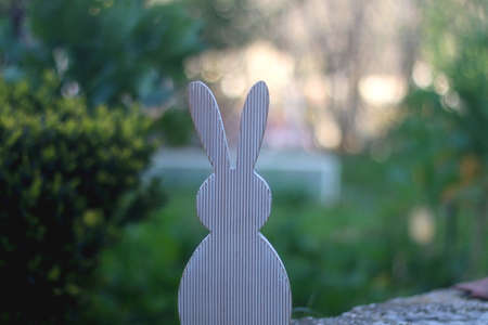 Wooden Easter bunny decoration in a garden. Selective focus.の写真素材