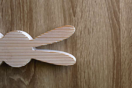 Wooden Easter bunny decoration on wooden background. Flat lay.の写真素材