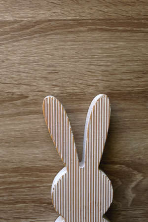 Wooden Easter bunny decoration on wooden background. Flat lay.の写真素材