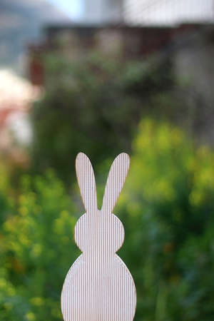 Wooden Easter bunny decoration in a garden. Selective focus.の写真素材