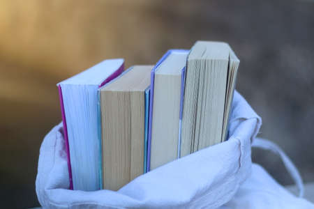 Linen tote filled with books. Selective focus.の写真素材