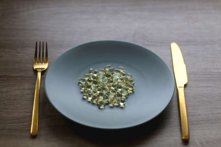 Vitamin D pills on a plate. Selective focus.の写真素材