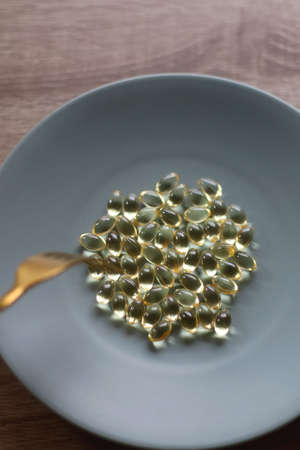 Vitamin D pills on a plate. Selective focus.の写真素材