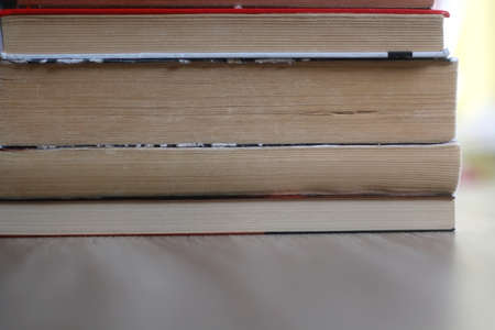 Stack of old books on a table. Selective focus.の写真素材