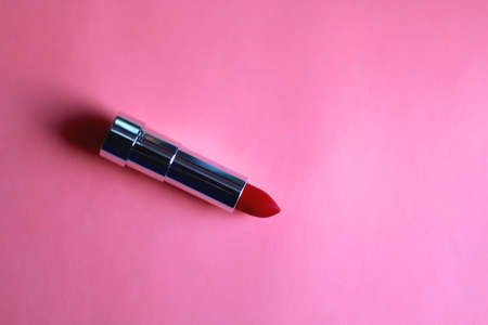 Red lipstick on bright pink background. Flat lay.の写真素材