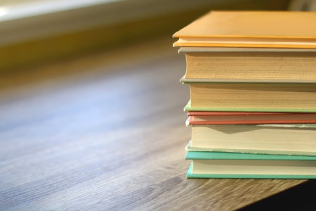 Stack of colorful books on a table. Selective focus.の写真素材