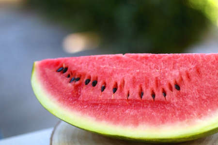 Slice of watermelon, served in a garden. Selective focus.