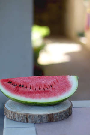 Slice of watermelon, served in a garden. Selective focus.
