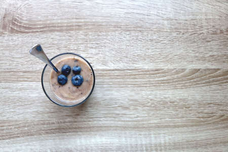 Banana and blueberry vegan nice cream, served on wooden table. Flat lay.の写真素材