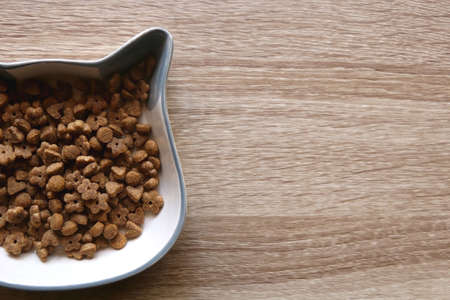 Cat shaped bowl filled with dry cat food. Top view.の写真素材