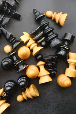 Vintage wooden chess pieces on dark background. Flat lay.の写真素材
