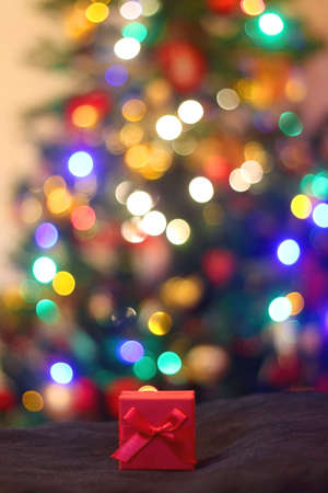 Small red Christmas present under the Christmas tree. Selective focus.の写真素材