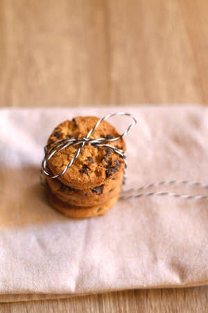Stack of chocolate chip cookies, tied with ribbon. Selective focus.の写真素材