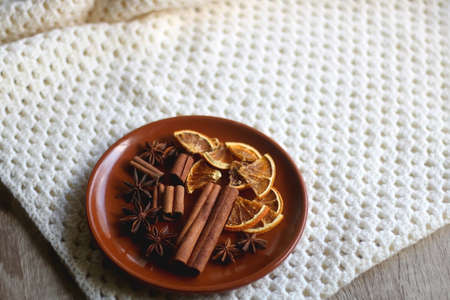 Plate of various winter spices and knitted blanket. Selective focus.の写真素材