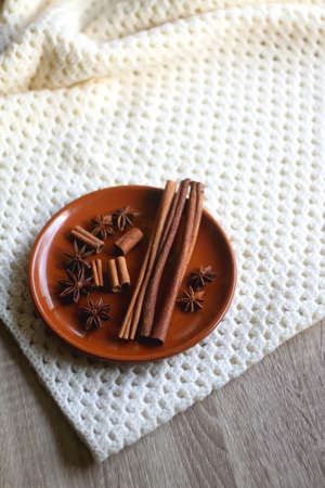 Plate of various winter spices and knitted blanket. Selective focus.の写真素材