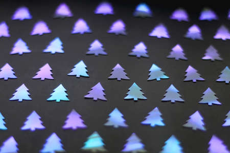 Pastel colored Christmas confetti on dark background. Selective focus.の写真素材