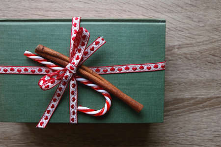 Two hardcover books, wrapped with ribbon, candy cane and cinnamon stick. Giving a gift of knowledge...