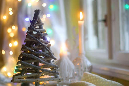 Rustic wooden Christmas tree decoration with bokeh lights in the background. Selective focus.の写真素材