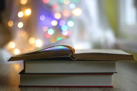 Stack of vintage books and colorful bokeh lights. Selective focus.の写真素材