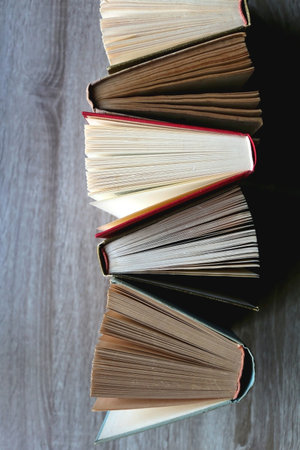 Bunch of vintage hardcover books on wooden background. Top view.の写真素材