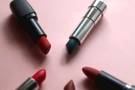 Lipsticks in various shades and colors on bright pink background. Selective focus.の写真素材