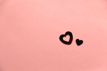 Red heart shaped confetti on pastel pink background. Flat lay.の写真素材