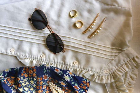 Vintage white blouse, floral scarf, round sunglasses, gold rings and pearl hair barrettes. Flat lay.の写真素材