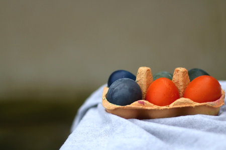 Egg carton with six painted eggs on the table. Selective focus.の写真素材