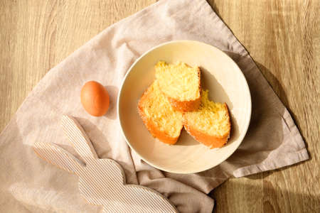 Plate of traditional sweet bread, eaten at Easter time in Croatia. Easter bunny, eggs and flowers on the table. Top view.の写真素材