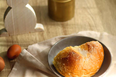 Plate of traditional sweet bread, eaten at Easter time in Croatia. Easter bunny, eggs and flowers on...