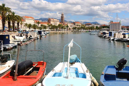 Promenade in Split, Croatia with landmark architecture and sailing boats.の写真素材